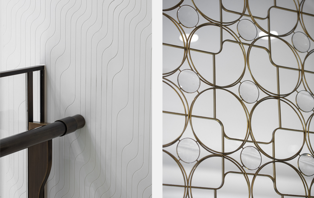 SKP brand detailing expressed through tactile interior finishes, from engraved wall panels and bronze handrail junctions to decorative metalwork that translates the SKP Curve into pattern, structure and material rhythm.