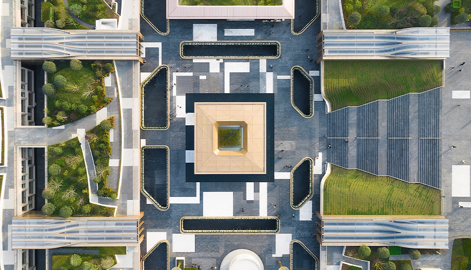 A bird’s-eye view of SKP Chengdu reveals the geometric order of the public realm, with the Central Cube, water features, planted edges and stone paving forming a precise landscape above the subterranean retail destination.