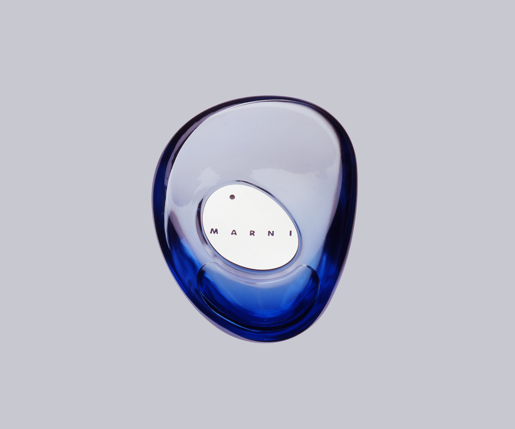 Marni product design detail showing a sculptural blue perfume bottle, with an organic translucent form that reflects the brand’s playful material language and distinctive visual identity.