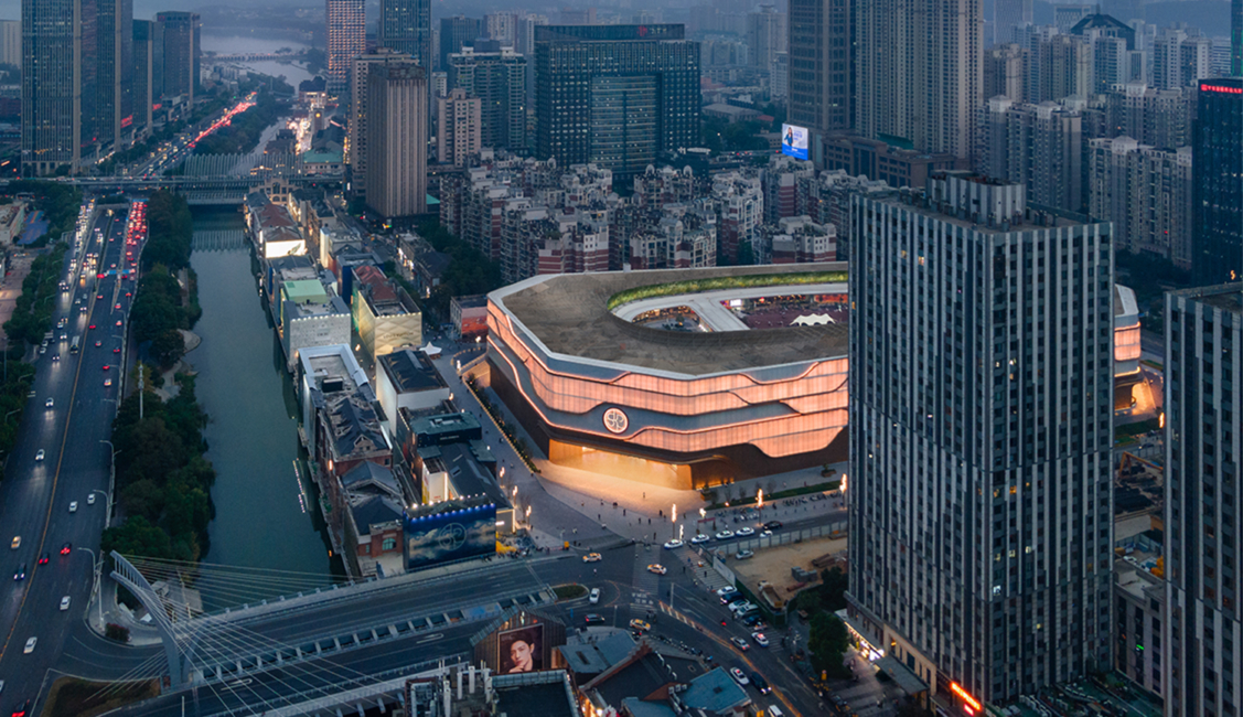 SKP Wuhan is set within the density of the city, its softly illuminated façade and flowing SKP Curve creating a distinctive urban landmark that connects luxury retail with the surrounding streets, canal and skyline.