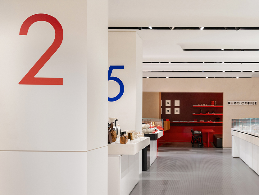 Harvey Nichols display tables use bold colour blocking, glass vitrines and clean architectural lines to create a precise, modular retail presentation system.