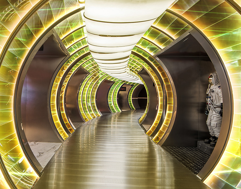 SKP-S Episode 1 - Moving to Mars - Beijing uses a luminous tunnel sequence to create an immersive retail journey, where iridescent surfaces, circular portals and theatrical lighting evoke a futuristic world in the space.
