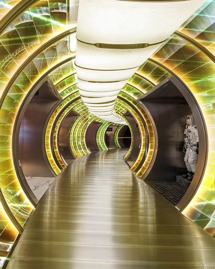 SKP-S Episode 1 - Moving to Mars - Beijing uses a luminous tunnel sequence to create an immersive retail journey, where iridescent surfaces, circular portals and theatrical lighting evoke a futuristic world in the space.